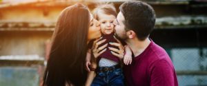 Couple kissing child - Adoption Help in Arizona