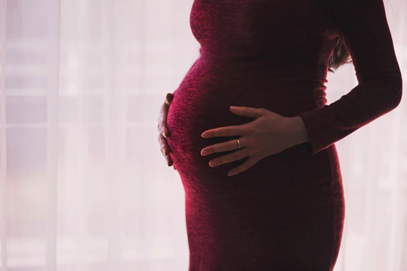 Pregnant Woman Holds Hands on Belly — Phoenix, AZ — Arizona Adoption