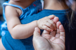 Father and child holding hands