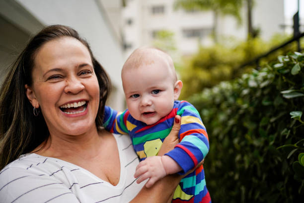 A-woman-is-smiling-and-holding-a-baby-—-Phoenix-AZ